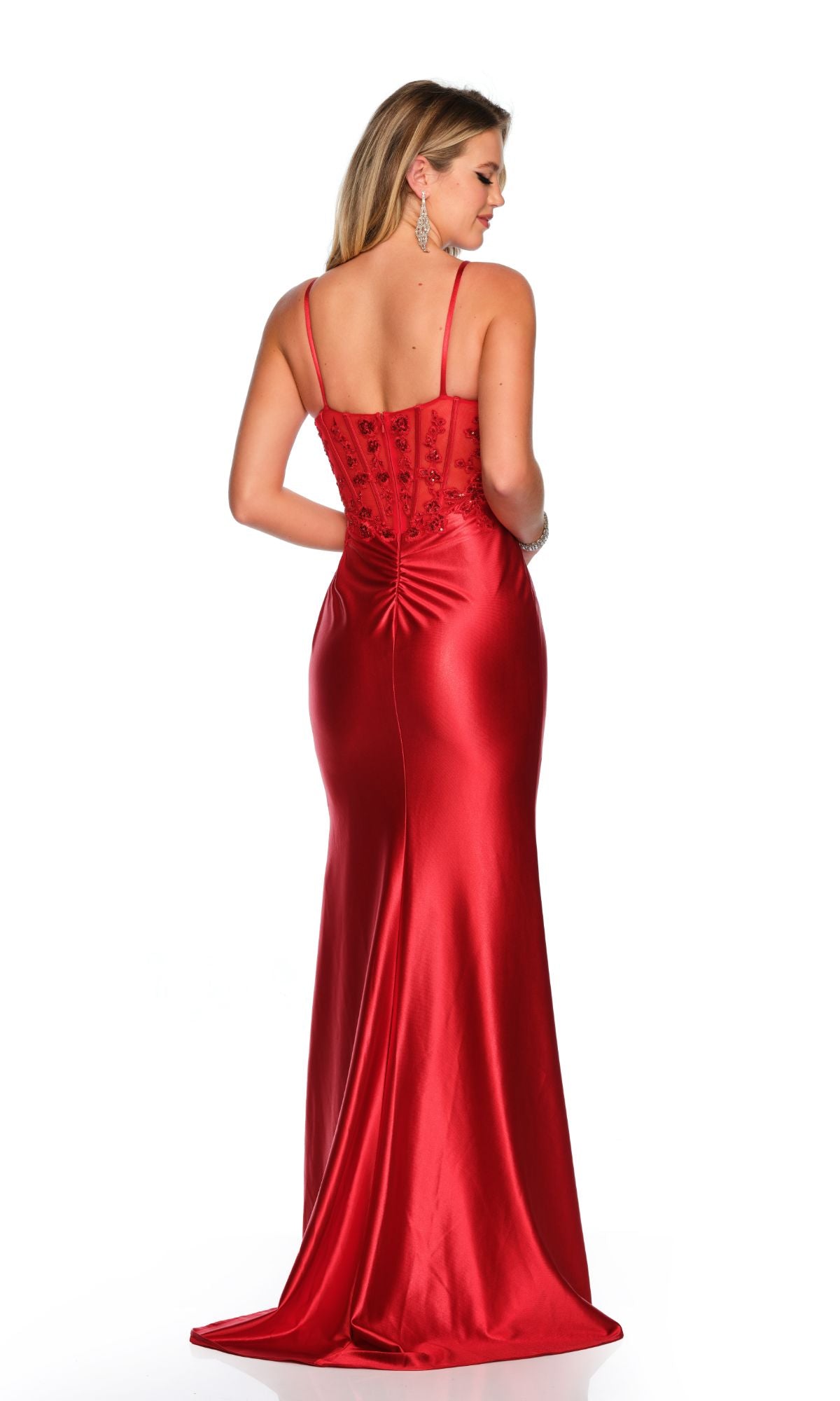 Woman wearing the Long Formal Dress 11537 by Dave and Johnny—sleeveless, floor-length red gown with thin straps and a fitted, lace-embroidered bodice—stands facing away against a white background.